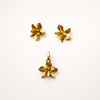 “Casa Bonita cayena Hibiscus earrings and pendant set in 24k gold-plated bronze, handcrafted by Colombian Artisans, luxury botanical jewellery.”
