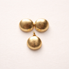 Handcrafted Colombian jewellery set inspired by the corozo fruit from Colombia’s Caribbean coast, featuring gold dome earrings and pendant created by women Artisans using traditional techniques.